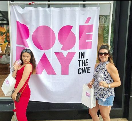 Two guests posing at the Rosé Day in the CWE backdrop